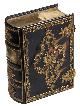  [BOOK-SHAPED BOX - QUEEN ANNE]., [Gold and tortoise shell book-shaped box made for Queen Anne of Great Britain].[Portugal?], [ca. 1702?]. Ca. 15.5 x 12 x 5.5 cm. Early 18th-century, possibly Portuguese, tortoise shell box, with elaborate gold filigree rococo decorations: birds and foliage within a floral frame on the front and back "boards" with gold filigree decorated fastenings around the "fore edge", complete with: 2 catch plates, 2 anchor plates and 2 clasps. The "spine" is divided into 4 compartments, separated by gold filigree decorative horizontal strips, with a gold engraved plaque in the 2nd compartment reading in a banner "BY ME KINGS REIGNE" and below "ANNE [a crown] REGINA" and a filigree basket of flowers in the 1st, 3rd and 4th compartments. The edges are embossed and covered in fine gold foil. The inside of the box is covered in red velvet and the front "board" is, once the box is open, connected to the outer corners of the "fore edge" by fine gold chains.